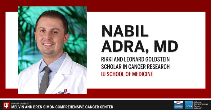 Portrait of Dr. Nabil Adra in a white lab coat with a tie.