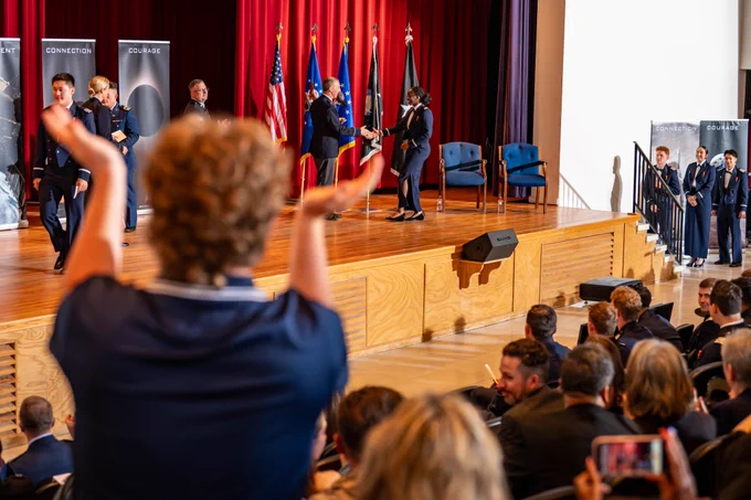A woman applauds during the Space Force Patching Ceremony at the U.S. Air Force Academy.