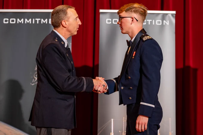 A U.S. Air Force Academy male cadet shakes hands at the Space Force Patching Ceremony.