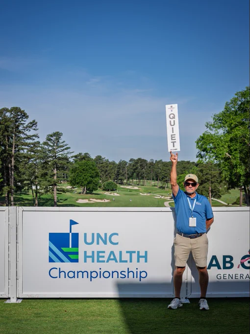 Volunteers perform various tasks throughout the UNC Health Championship, including greeting guests, assisting with operations, providing directions, and supporting activities across the course
