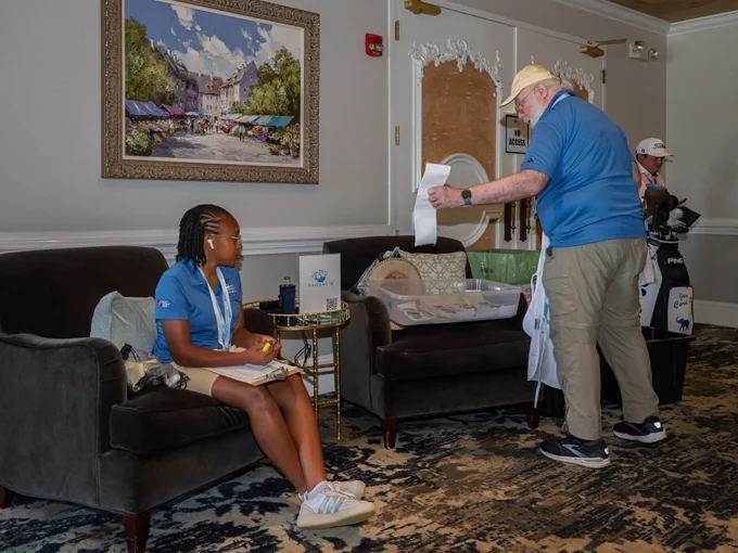 Volunteers perform various tasks throughout the UNC Health Championship, including greeting guests, assisting with operations, providing directions, and supporting activities across the course