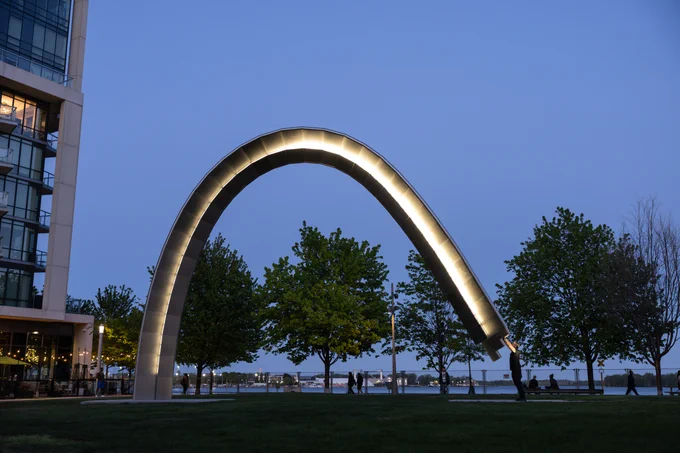 Artist Rafael Lozano-Hemmer activating Unfinihsed Arch at night in Sherbourne Common.