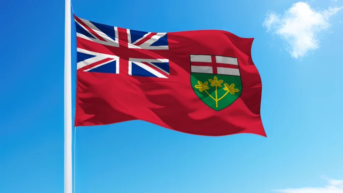 Ontario provincial flag waving on a flagpole against a bright blue sky with a few white clouds.
