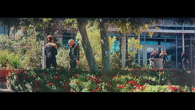 Five officers, including two talking in the foreground at the University Center. Still image from Star Trek Picard (Paramount Pictures). University Center in the present day (at sunset).