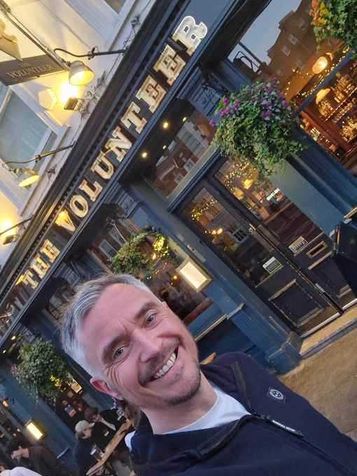 Allan in front of The Volunteer, a haunted pub.