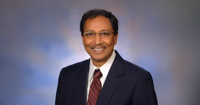 Headshot of Doctor Subrata Roy in a suit, smiling.