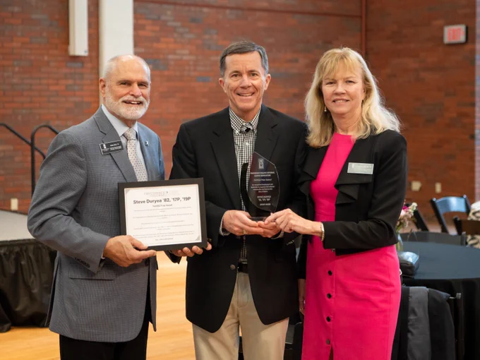 Steve Duryea '82 is presented with the Faithful Friar Award by NAC president Kathleen McGinley '82 and vice president Richy Kless '74, '78G, '82SCE