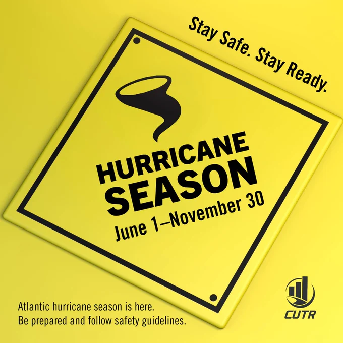 Yellow road sign with black cyclone icon. "Hurricane Season, June 1 to Novemeber 30," is centered in bold text. 