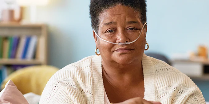Image of an older adult wearing an oxygen tube.