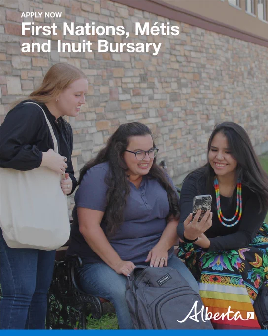 Three individuals are seated and standing near a stone wall outdoors looking at a smartphone one of them is holding. The person holding the phone is wearing a colorful, ribbon skirt and beaded necklace. Overlaid text reads: “Apply now – First Nations, Métis and Inuit Bursary,” with the Alberta logo.