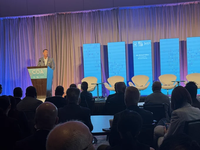 Broward County Commissioner Michael Udine greets attendees at the Airports Conference of the Americas.