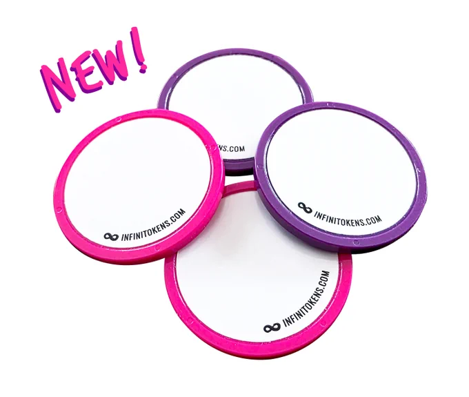 A photo of four InfiniTokens dry erase counters. Two are hot pink and two are dark purple.