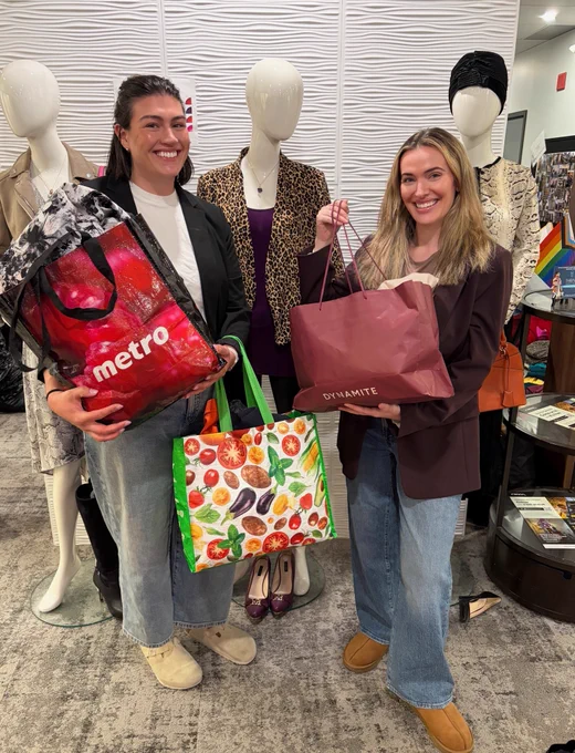 Two women dropping off donation bags 