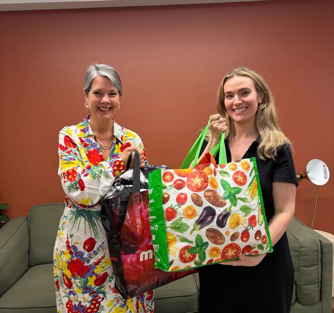 Women with donation bags for clothing drive