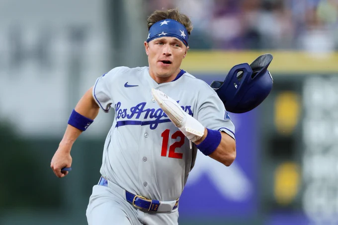 Alex Call running in a grey Los Angelese Dodgers uniform