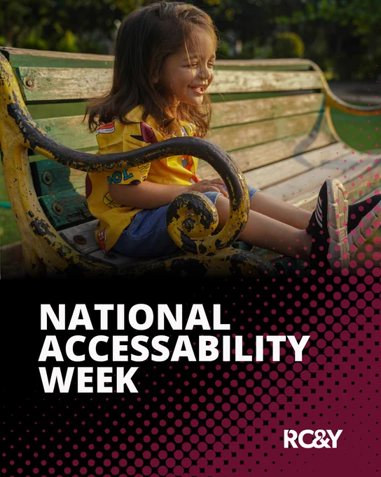 A smiling young child sits sideways on a weathered green park bench in warm sunlight, wearing a bright yellow shirt and denim shorts. The lower half of the image features bold white text reading “National Accessibility Week” over a black background with a magenta halftone dot pattern. The RCY logo appears in the bottom right corner.