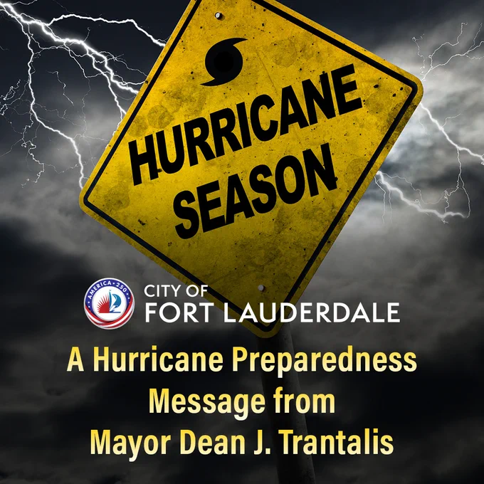 Yellow warning sign reading 'Hurricane Season' against a stormy sky with lightning bolts in the background.