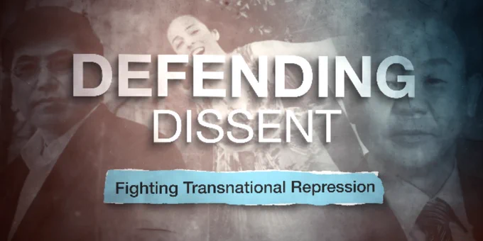 Three people lying on the ground holding hands beneath the words 'Defending Dissent' and a banner reading 'Fighting Transnational Repression'.