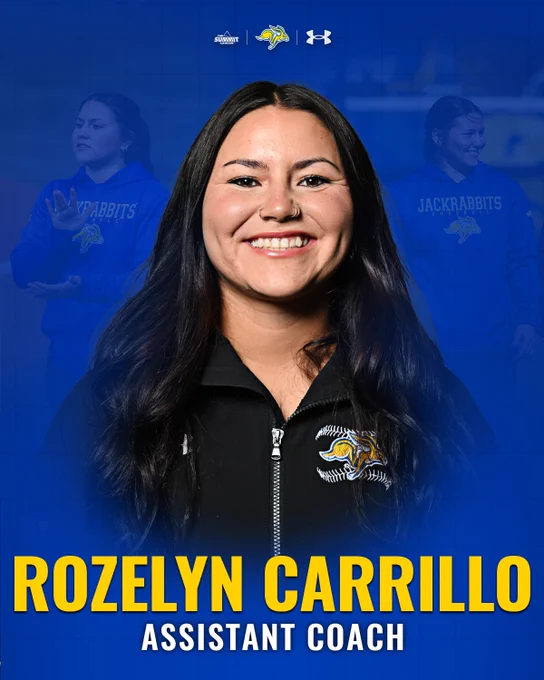 Graphic featuring a centered head-and-shoulders portrait of a person wearing a black zip-up jacket with a South Dakota State Jackrabbits softball logo. The blue background includes faint images of the same person coaching and logos for The Summit League and Under Armour at the top. Large yellow text at the bottom reads “ROZELYN CARRILLO,” with smaller white text below reading “ASSISTANT COACH.”