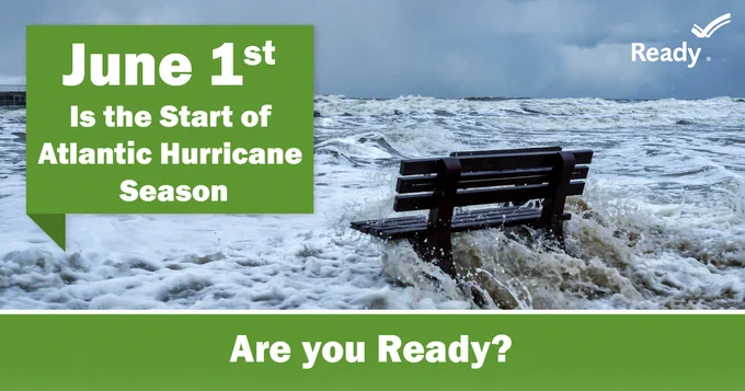 A lone bench partially submerged by turbulent ocean waves under a stormy sky. Text reads "June 1st is the start of Atlantic Hurricane Season. Are you ready?"