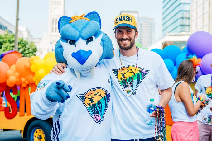 Image of Gnash and Roman Josi posing for a photo at the Nashville Pride Parade 
