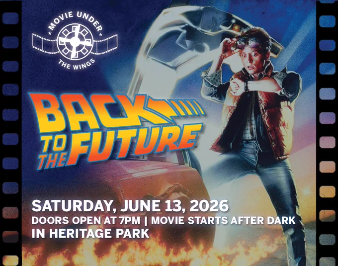 Promotional poster for Back to the Future movie screening on June 13, 2026, at Heritage Park with a character standing beside a DeLorean car emitting flames.