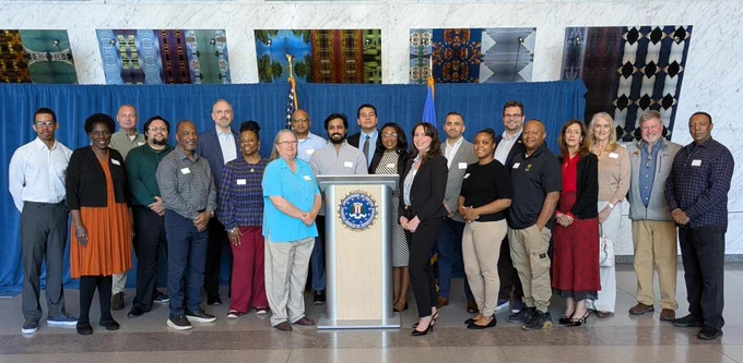 The 2026 Citizens Academy class poses in front of an FBI podium.