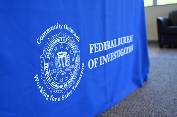 Blue tablecloth with the FBI seal and text promoting community outreach for a safer tomorrow.