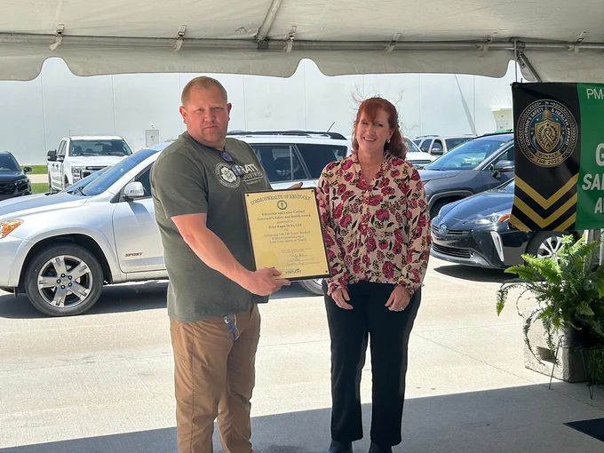 KYSAFE Director Lynn Whitehouse presents the Governor's Safety and Health Award to a Pratt Paper representative.