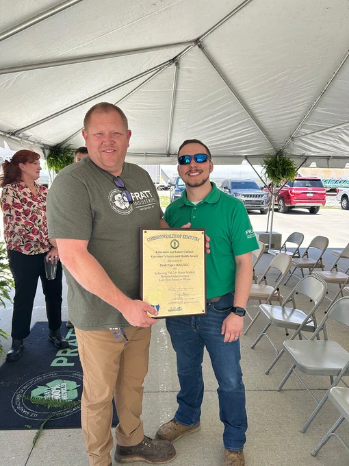 Two people posing with the Governor's Safety and Health Award.