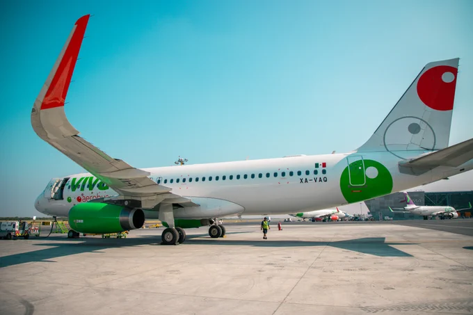 A Viva A320, registered XA-VAQ, is parked on a sunny day. It is fitted with SES's multi-orbit, ESA-based IFC solution