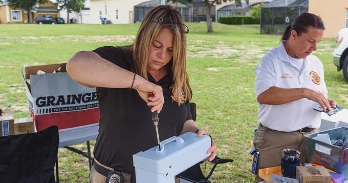 PCFR’s Public Education Manager Kathy Sellen and Deputy Chief Jennifer Huff assembling pool safety equipment.