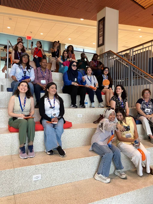 EducationUSA advisors seated on tiered steps in the Reitz Union.
