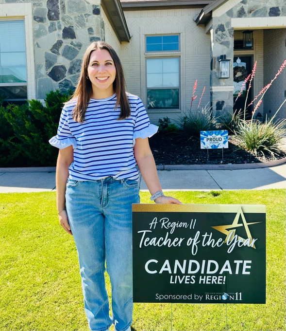 Brooke Cray, Weatherford ISD Elementary Teacher of the Year, posing with a "A Region 11 Teacher of the Year Candidate Lives Here!" yard sign. Behind Brooke is a grassy, green yard and a stone and light brick house.