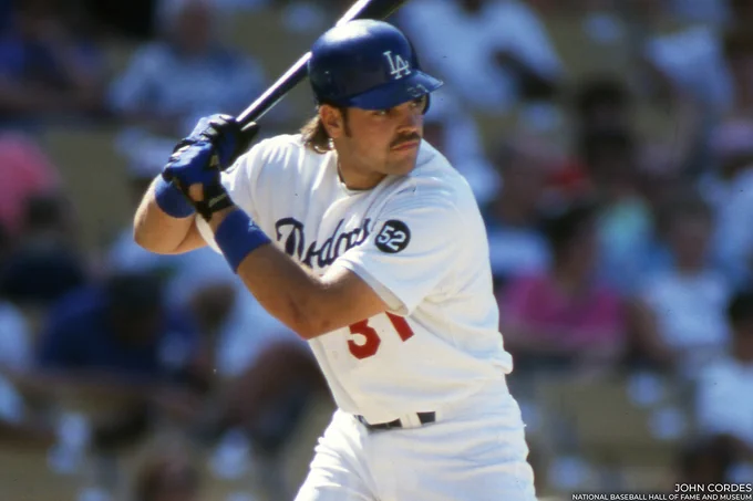 Mike Piazza wearing a home Dodgers uniform and standing in the open side of his right-handed batting stance. (John Cordes/National Baseball Hall of Fame and Museum)