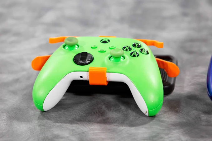 Pictured is a photo of an Xbox video game controller that have been modified with snap-on modifications so they can be used by everyone.