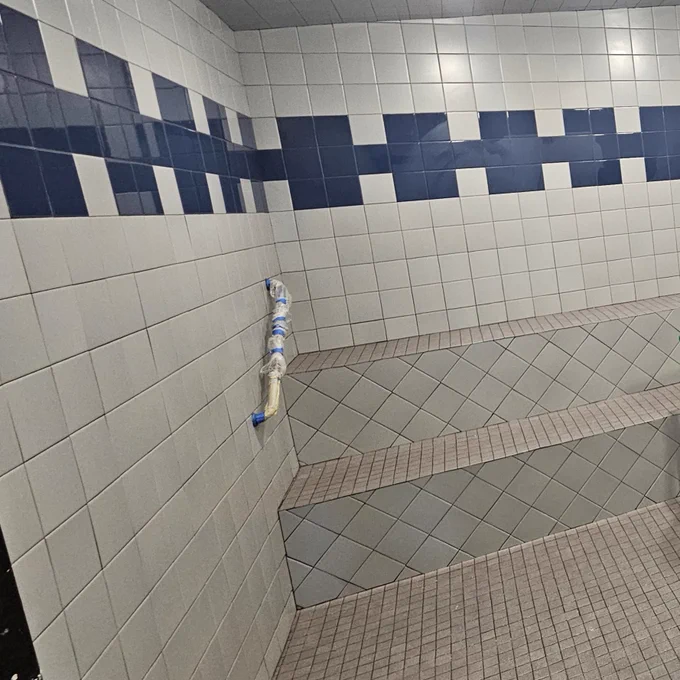 The Family FunPlex steam room is sporting new tile - with a blue border at the top above the sitting area. 