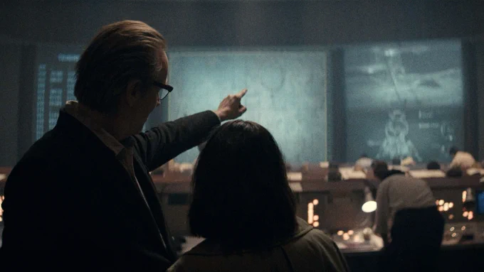 The Chief Designer (Rhys Ifans) with Svetlana Leonova (Jenny Walser) at the back Moscow Mission Control in the first episode of the "For All Mankind" spinoff, "Star City." (Apple TV)