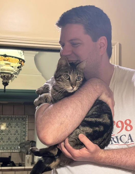 Peter holding a tabby cat