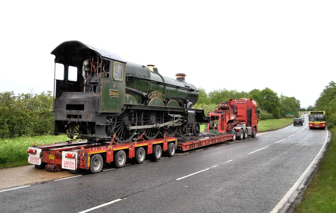 GWR Castle class locomotive 5080 "Defiance" on a heavy haul low loader lorry on the A41 at Fleet Marston, Buckinghamshire,