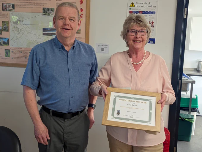 Babs Byrom receiving the Pitstone Volunteer of the Year 2026 award from Parish Council Chairman Dave Nicholls