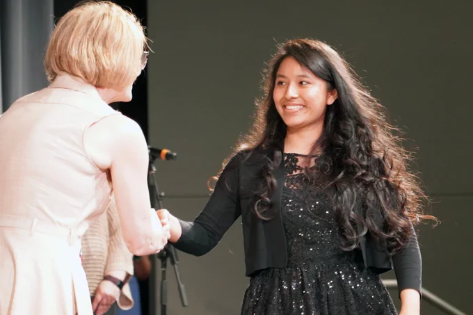 adult student receives diploma at Bloomington Transition Center completion ceremony