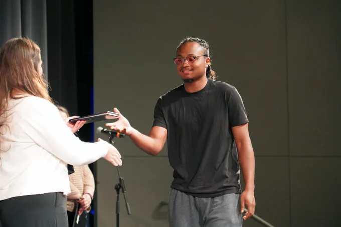 adult student receives diploma at Bloomington Transition Center completion ceremony
