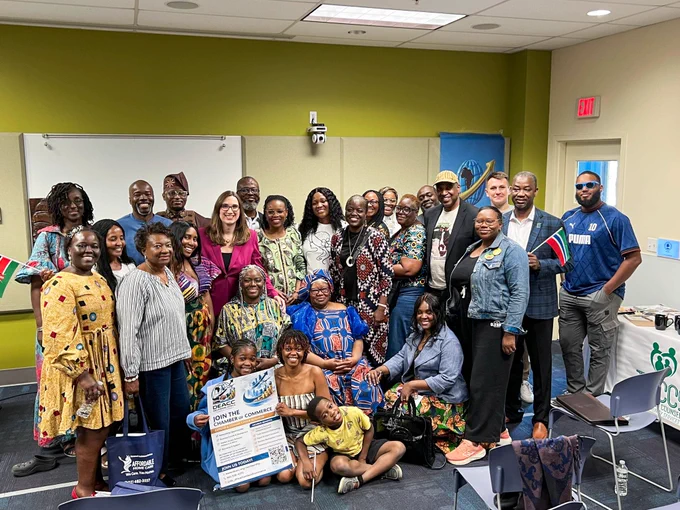 Rep. McBride poses with attendees at the Delaware Africa Chamber of Commerce's Africa Day celebration. 