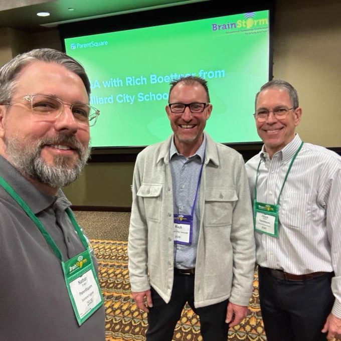 Three individuals standing indoors in front of a screen displaying the text: "Q&A with Rich Boettner from Hilliard City Schools." The screen also displays logos for ParentSquare and BrainStorm.