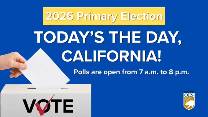 A hand places a ballot into a box with the word "Vote" on it. 