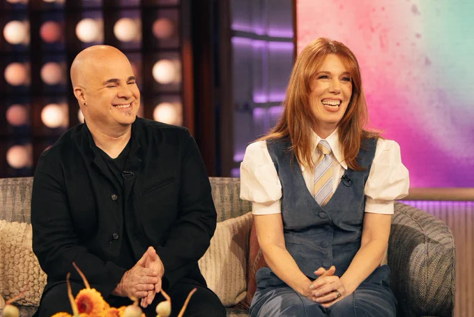 Image of Rhonda & Jason on set of The Kelly Clarkson Show laughing.