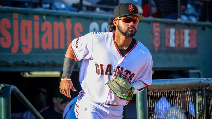 Jhonny Level wearing a white San Jose Giants uniform