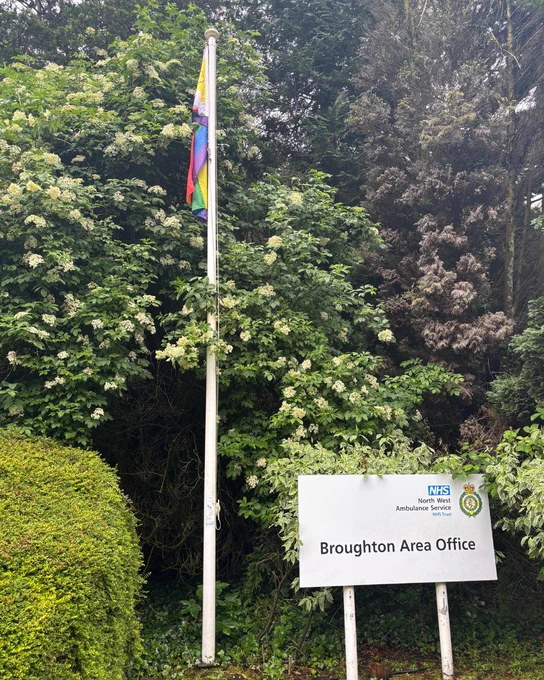 The Progress Pride flag flies outside Broughton Area Office, with the NWAS site sign visible in the foreground.