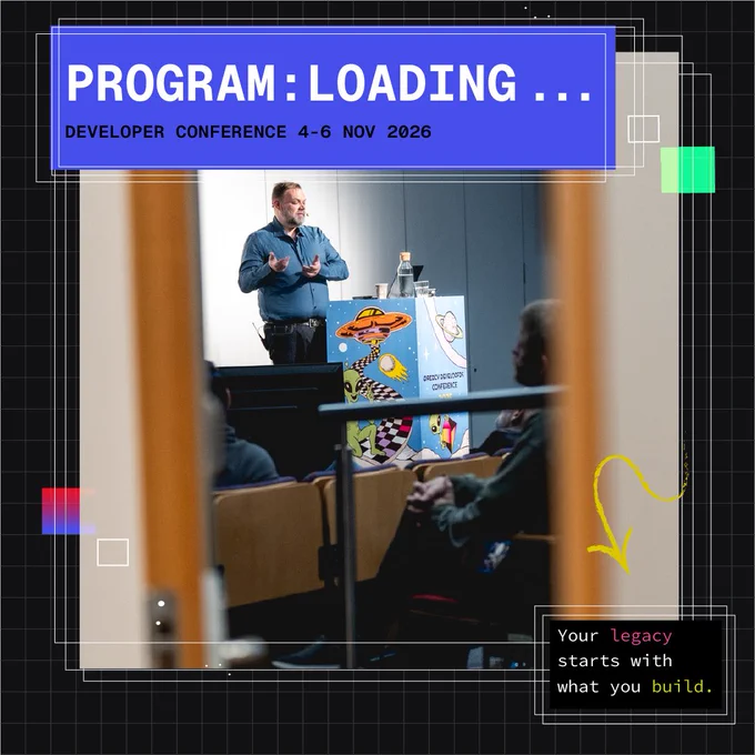 Doors opening to a speaker presenting at the Øredev developer conference with a colorful podium and attendees seated in a dimly lit room.